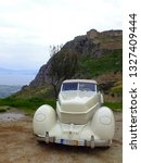 Small photo of CORINTH, GREECE, NOVEMBER 30, 2014. Classic american car Cord 810 Phaeton, of 1936, at Acrocorinth rock with the ancient castle in the background.