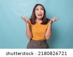 Small photo of beautiful young woman crying feeling very depressed isolated by blue background shouting loud