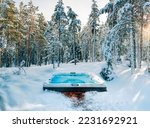Small photo of Hot tub in the middle of a beautiful winter forest. Nothing is more relaxing than a soak in a hot tub on a cold winter's day.