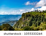 Kerio Escarpment, Great Rift Valley, Kenya, Africa. Landscape view of the tree covered escarpment, looking into the distance, to the mountains of the Great Rift Valley. Few clouds in sky. Copy space. 