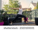 Small photo of Middle aged male female student to do Exalted Crescent Lunge while practicing yoga on home terrace on peaceful summer morning. Concept doing Exalted Warrior asana in nature