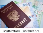 Small photo of Moscow, Russia- 08 28 2018: Russian passport. The Russian Currency, including the new 2000 ruble-denominated promissory notes. The MIR credit card