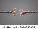 Small photo of Frayed rope about to break concept for stress, problem, fragility or precarious business situation