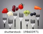Fruit and vegetable of silver forks against a grey background concept for healthy eating, dieting and antioxidant