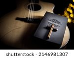 Small photo of Holy Bible with acoustic guitar and religious crucifix cross, gospel music concept