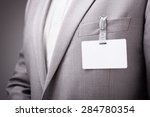 Businessman at an exhibition or conference wearing a blank security identity name card or tag