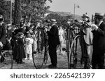 Small photo of DOMIGLIARA, VERONA, ITALY, FEBRUARY, 2023:Antique Bicycle Adventure: Carnival-goer Rides a Penny Farthing Through the Crowds