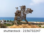 Small photo of Cerberus, in Greek mythology, often referred to as the hound of Hades, is a dog that guards the gates of the Underworld to prevent the dead from leaving. Cyprus, Ayia Napa - Sculpture Park 2021