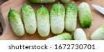 Small photo of Small fresh snack cocktail Dutch cucumbers Quirk variety on wooden background, healthy vegetarian organic food concept