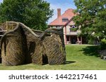 Small photo of Falmouth, MA - June 15, 2019: A Passing Fancy a stickwork sculpture by Patrick Dougherty while under construction on the grounds of Highfield Hall and Gardens.
