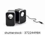Small computer speakers on white background.
