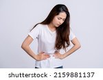 Small photo of A woman had a stomach ache and. She put her hand on her stomach and squeezed it to relax and soothe. She has menstrual cramps. Isolated white background.