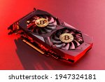 Two gold bitcoin on a  video Card with red backlight in the style of cyberpunk. Crypto currency. Bitcoin mining concept