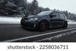 Small photo of Helsinki, Finland - December 15, 2022 Volkswagen Golf Mk7 GTI black. on the road in the forest in snowy winter