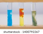 Small photo of Three test tubes containing (left to right) precipitate of copper hydroxide, precipitate of iron (III) hydroxide and precipitate of iron (II) hydroxide. All were made by adding sodium hydroxide.