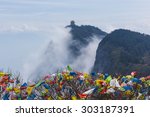 The Thousand Buddha Temple on a distant peak of Emeishan, with prayer flags, Sichuan province