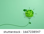 Green crumpled paper light bulb on green background, Corporate Social Responsibility (CSR), eco-friendly business and environmental concepts, copy space