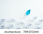 Group of paper ship in one direction and one individual pointing in different way. innovative solution for business concept.