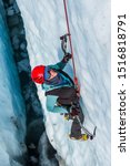 Small photo of Ice climbing guide inside a water filled crevasse on the Matanuska Glacier. She is ice climbing out of the crevasse after being lowered in from the top.