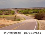 A highway traversing an agriculture area in the Oklahoma panhandle.
