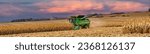 Small photo of Kenyan, Minnesota - 11-2-2019: A panorama image of a combine harvest tine corn in a field near Kenyon, Minnesota. Combine throwing dust and straw in the air.