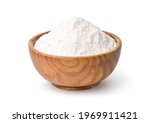 White flour in wooden bowl isolated on white background. Clipping path.