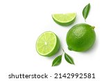Flat lay of fresh lime with  cut in half and leaves isolated on white background.