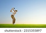 Small photo of Asian man golfer driver swing before hitting golf ball down the fairway.