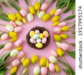 Small photo of Colorful easter quail eggs in nest and tulips on pink background with . Flat lay. Spring composition. Happy easter greeting card.