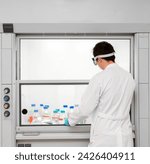 Small photo of Fume hood. Chemical and biological laboratory. Ventilation equipment for experiments. lab fume cupboards. Scientist working in a fume cupboard in laboratory research.