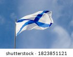 Small photo of St. Andrew's flag waving on a blue sky background. Ensign of the Russian Navy. Naval flag of the Russia. Concept of Russian navy day.