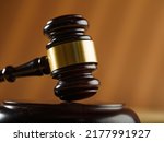 Close-up. Wooden judge's gavel on a beige background. Court, justice, presumption of innocence, Constitution, rule of law, auction. Banner, poster. There is no one in the photo.