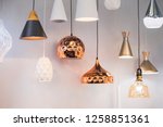 Small photo of Different modern streamlined mirror copper chandeliers. Bubble metal copper shade pendant.