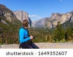 A photographer enjoys view of Yosemite Falls at Inspiration point view in the Evening, Relaxing with Nature scene