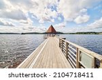 The Church Bridge (Kyrkbryggan), a wooden bridge with pavilion out in the large Lindesjön lake (Stora Lindesjön) right at the foot of Lindesberg church in the town of Lindesberg.