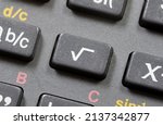 Small photo of Square root math operation symbol, sqrt icon on a scientific calculator button, key object macro detail extreme closeup, nobody. Mathematical operations, mathematics education abstract concept