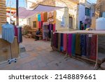 Small photo of Jaisalmer, Rajasthan, India - October 13, 2019 : Colourful ladies clothes are displayed for sale to tourists in market place Inside Jaisalmer Fort, in the morning. Popular UNESCO world heritage site.