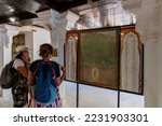 Small photo of Jaisalmer, Rajasthan, India - 15th October 2019 : Foreign tourists studying genealogy of Lord Shri Krishna displayed inside interior of Rani Mahal or Rani Ka Mahal, inside Jaisalmer fort.