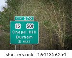 A highway sign leads drivers to Chapel Hill and Durham, NC.