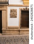 Small photo of Ronda, Malaga, Spain- October 21, 2023: Majestic facade of old house with carved stone blazon