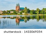 Cathedral in Gniezno town, Poland, on a bright day in Summer reflected in water