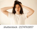 Small photo of Sad woman with migraine strong headache disease. Depression. Overstressed woman with head pain touches head