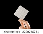Small photo of Close-up round acne patch on finger and set of patches in hands on black background. Acne patches for treatment of pimple and rosacea close-up. Facial rejuvenation cleansing cosmetology