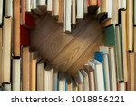 Love concept of heart shape from old vintage books on wooden floor background