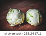 Small photo of Green round kohlrabi. Kohlrabi on a wooden kitchen table. Root vegetables. High content of medicinal effects and vitamins.