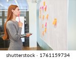 Thoughtful business woman or student brainstorming with sticky notes