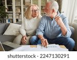 Small photo of Retired senior couple planning retirement and retirement through investment and insurance