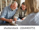 Small photo of Senior couple signs a contract or power of attorney or fills out an application