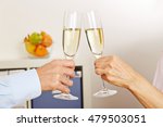 Old hands clinking champagne glasses for celebration