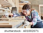Woman as joiner grinding wood